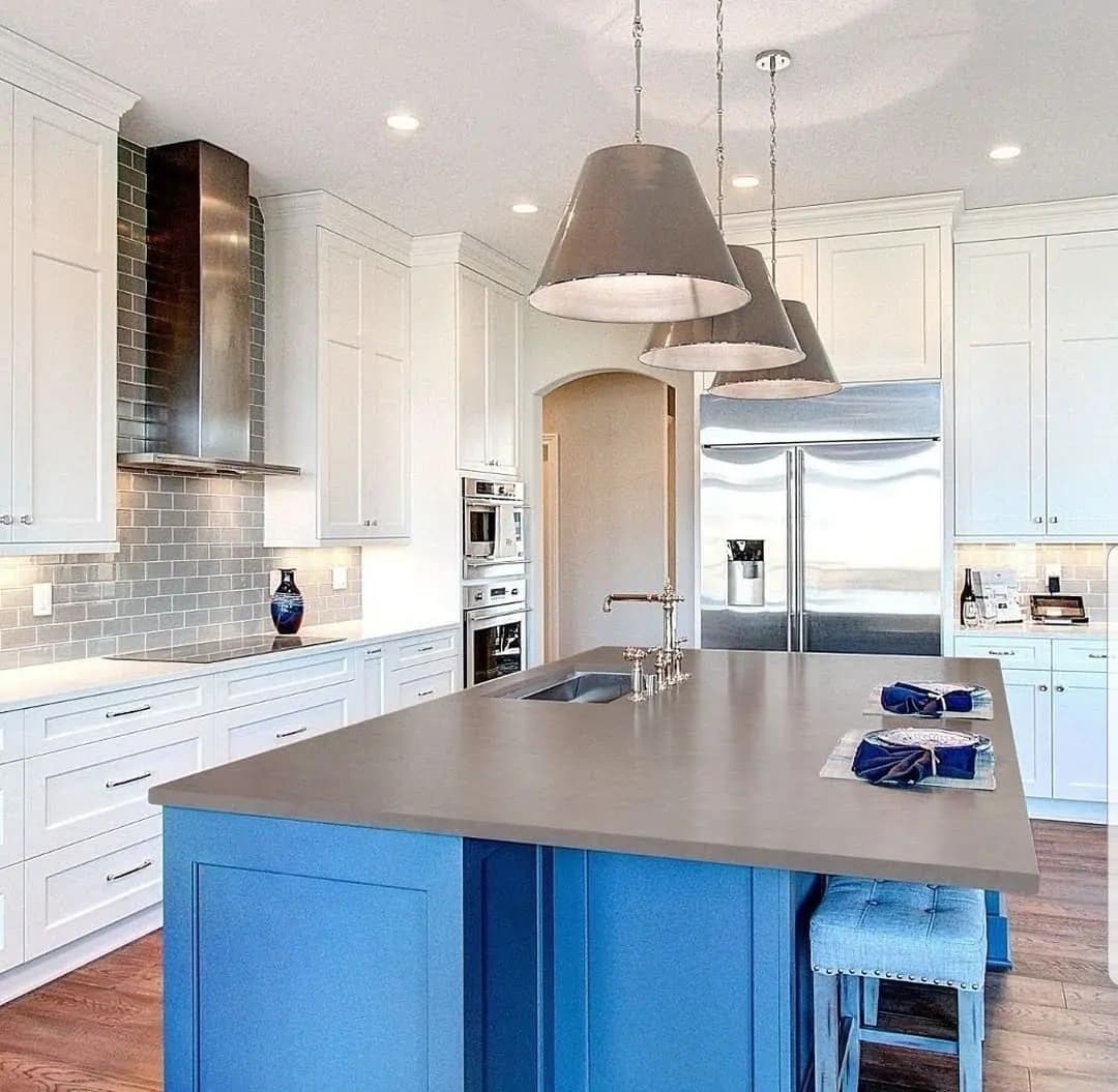 Finished kitchen renovation with white cabinetry and a blue island